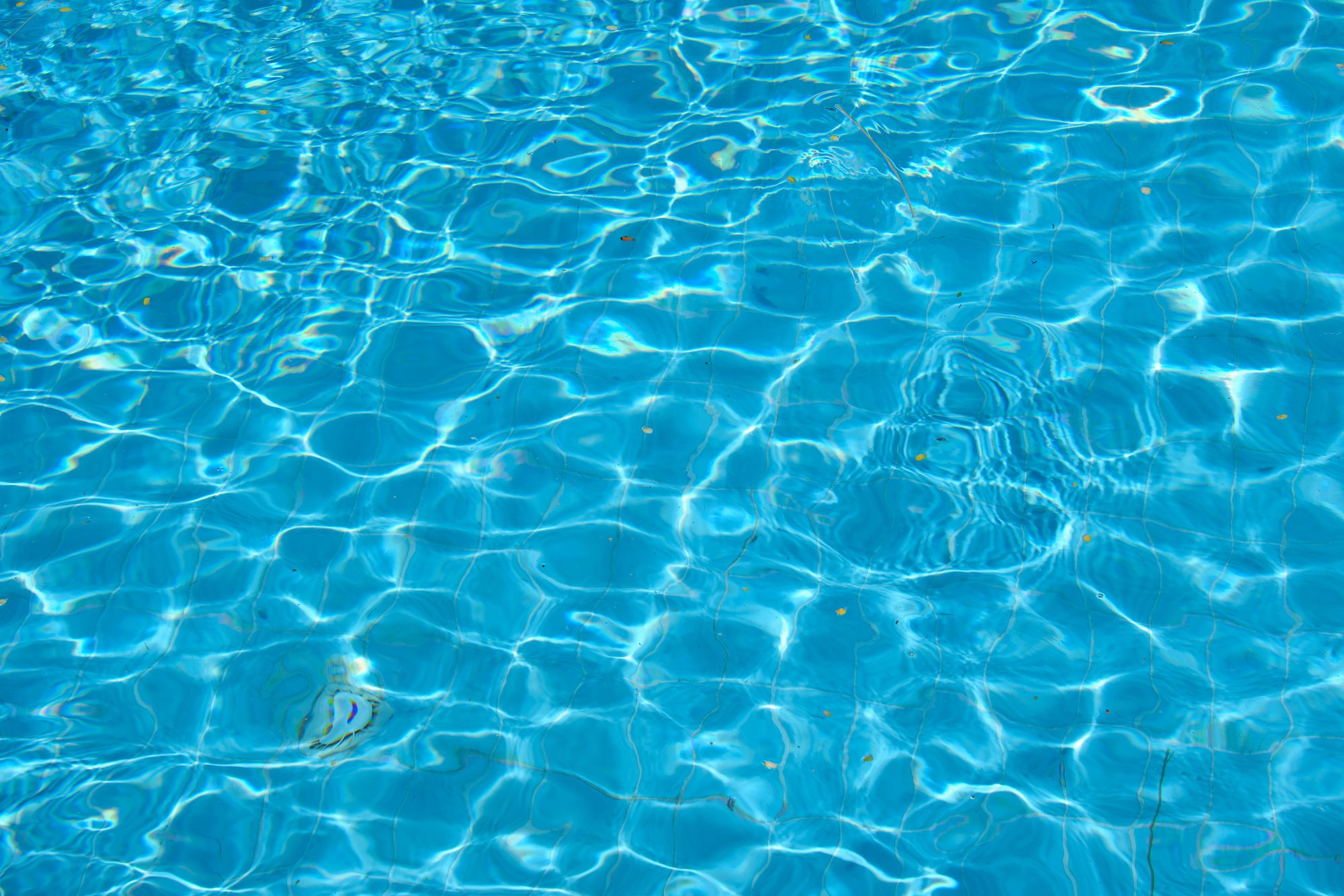 Closeup surface of blue clear water with small ripple waves